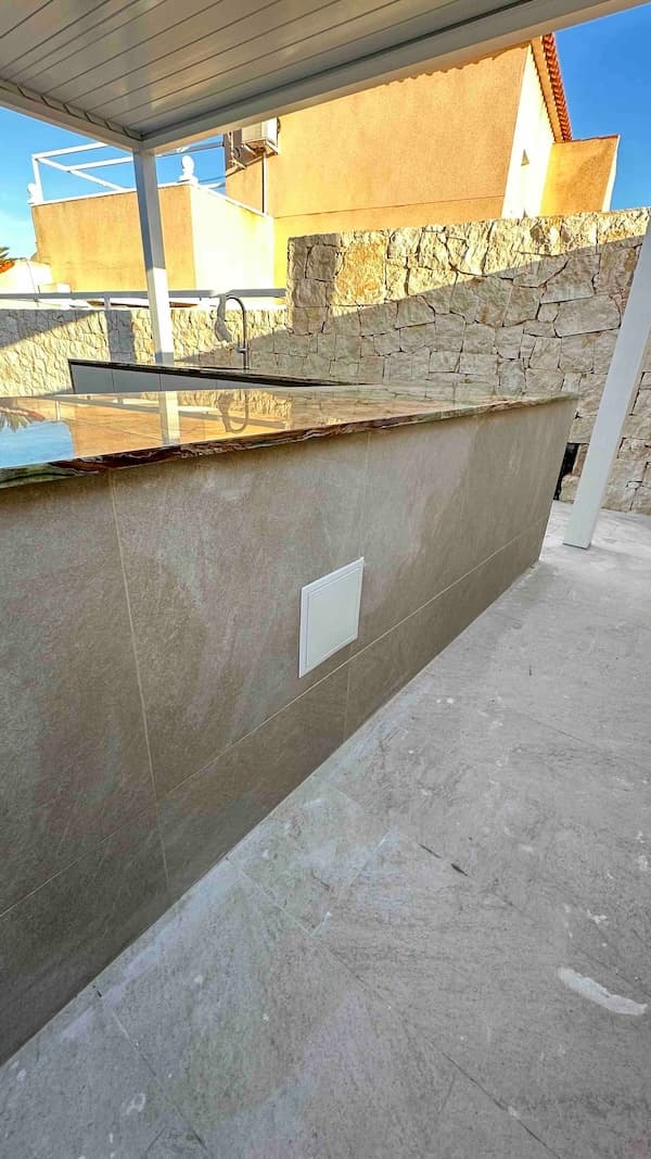Renovación de terraza con toldo y isla de cocina — imagen del proyecto