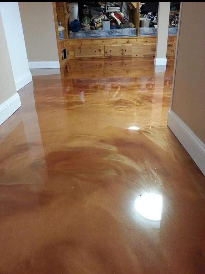 Pavimento de resina metalizada en tonos cobre y dorado en el pasillo de una vivienda